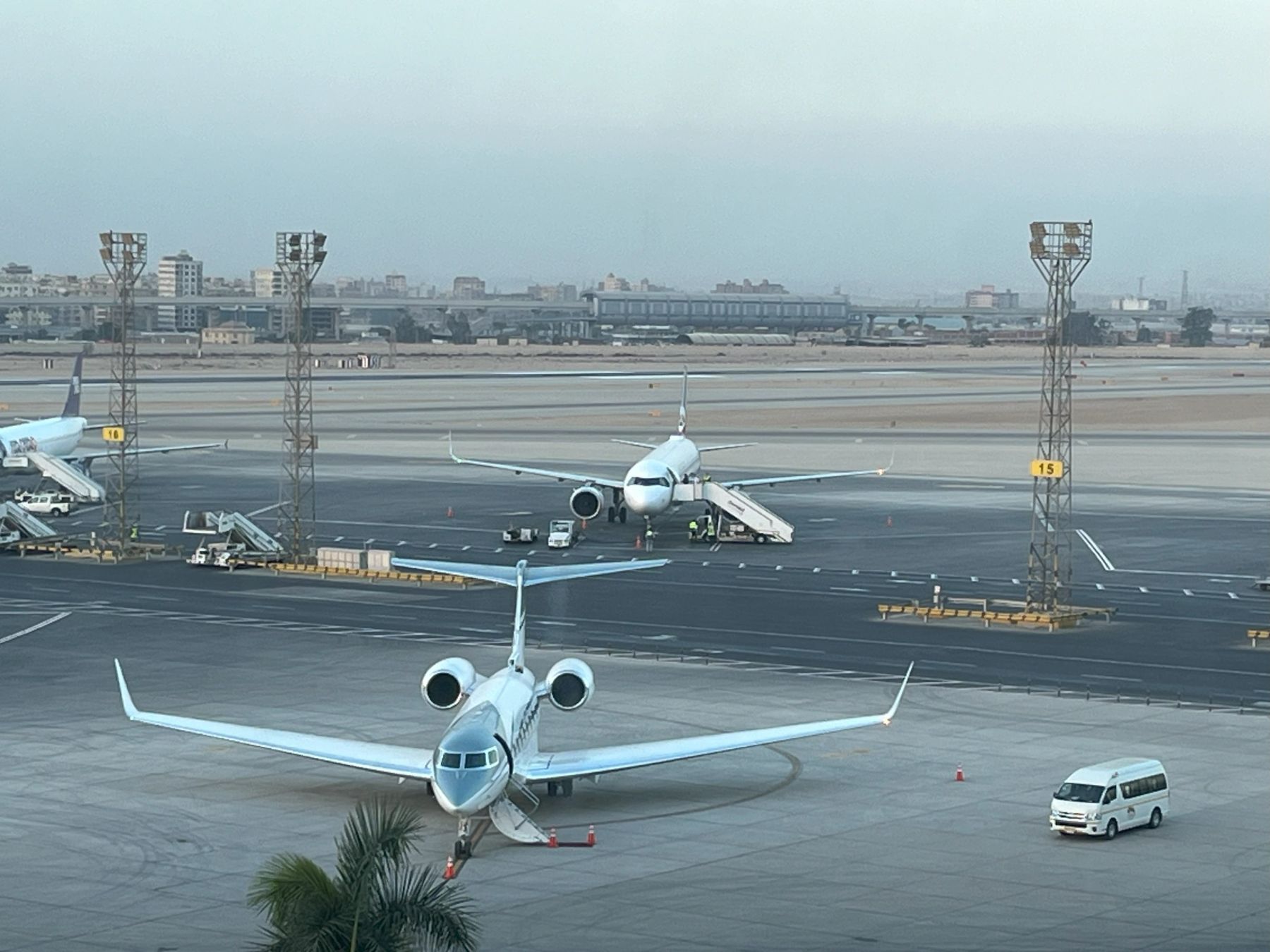 Business jet and airliner on the apron at Cairo International Airport